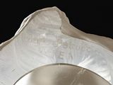 a close up of a silver vase with a black background