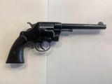 a close up of a revolver on a white surface