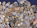 a pile of coins sitting on top of a blue table