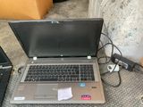 a laptop computer sitting on the floor next to other laptops