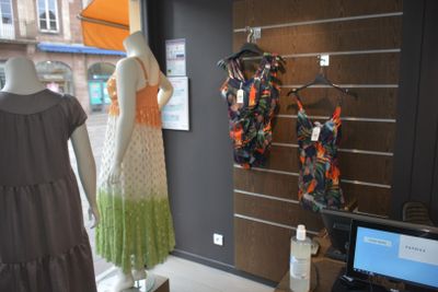 mannequins and dresses on display in a clothing store
