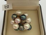 an image of a ring with pearls in a box on a table