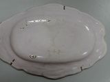 a white plate with a flower decoration on it