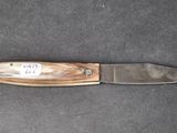 a knife that is laying on top of a table