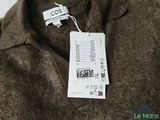 a label on a brown sweater that says cos