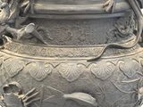 a large gray vase with a dragon design on it