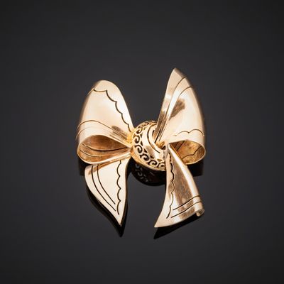 gold bow brooch on a black background