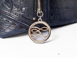 navy blue leather purse with a silver metal chain and a silver and black purse