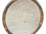 a round mirror with a floral design on it