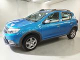 a picture of a blue dacia parked in a garage