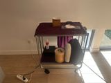 a table with a purple table cloth on it and a cup of coffee on top of it