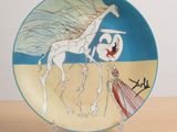 a plate with a picture of a woman and a giraffe on it