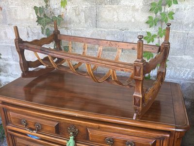 a wooden dresser with a magazine rack on top of it