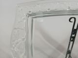a glass picture frame with a pair of scissors in it