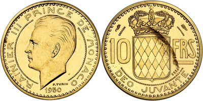 a close up of a gold coin with a crown on it
