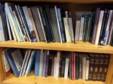 a book shelf with many books on it in a library