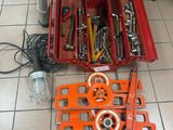 a red tool box with tools in it on the floor