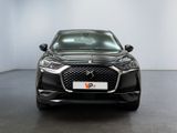 the front view of a black car in a white room