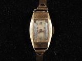 une image représentant une montre-bracelet en or sur laquelle figure le visage d'une femme