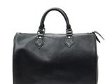 a black louis vuitton speedy bag on a white background