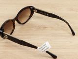chanel sunglasses on a table with a price tag on it