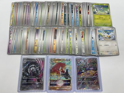 a lot of different pokemon cards on the table