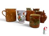 many different types of vases sitting on a table