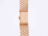 a close up of a watch on a white surface