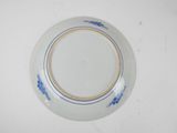 a blue and white plate on a white table