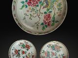three pieces of chinese porcelain with flowers and birds on a black background