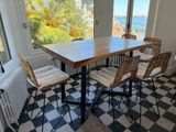 a table with four chairs and a radiator in front of a window