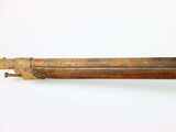 an old gun with a wooden handle on a white surface