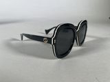 black sunglasses with gold details on the temples and arms