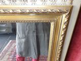 a woman standing in front of a mirror wearing red boots