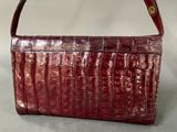 red alligator skin purse with gold hardware