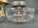 a glass bowl sitting on a table next to a candle holder