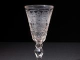 crystal goblet on a black table with a black background