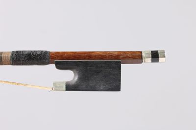 a bow with a wooden handle on a white surface