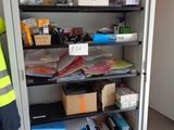 a metal cabinet with many items on it in a room