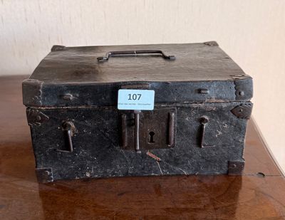 an old suitcase sitting on a table with a tag on it