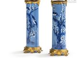 pair of blue and gold vases with birds and flowers on them
