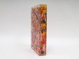 brightly colored lollipops in a clear box on a white surface