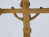 a cross that is on a stand in the snow