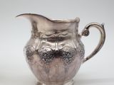 an image of a silver plated pitcher and a silver plated sugar shaker