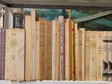 many books that are on a shelf in a window