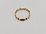 a gold ring on a white surface