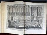 an open book with a drawing of a large building