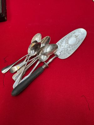 a lot of spoons and spoon spoons on a red table