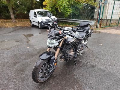 a motorcycle parked in a parking lot next to a van