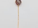 a close up of a stick with a stone on it